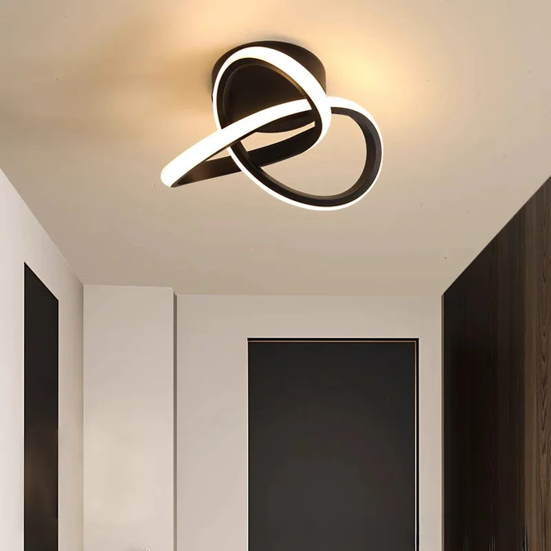Modern Scandinavian LED ceiling light with minimalist black loop design illuminating a passageway